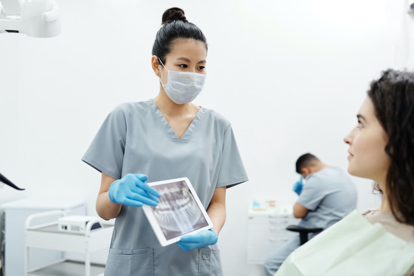 Dental Assistant discussing a dental xray with a patient