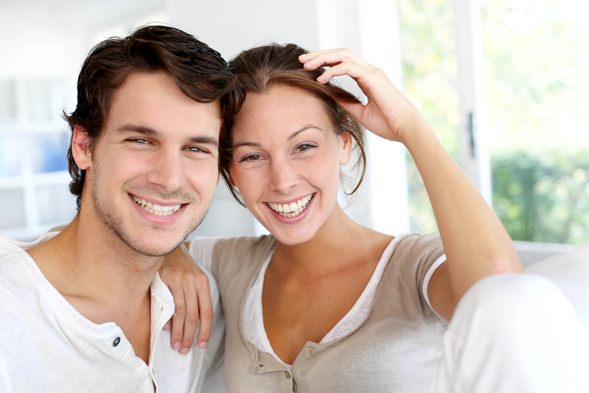 Couple smiling, displaying their white teeth